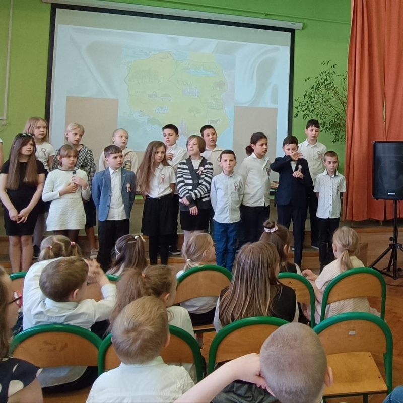 Przemówienie pani dyrektor oraz uczniowie trzeciej klasy na scenie
