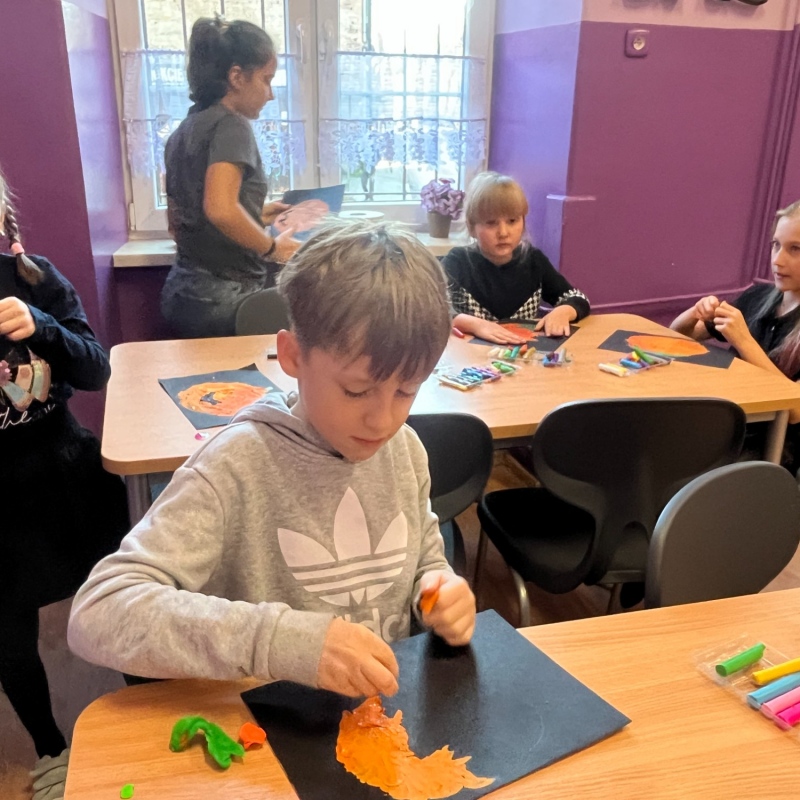 Uczniowie wykonują jesienne dynie