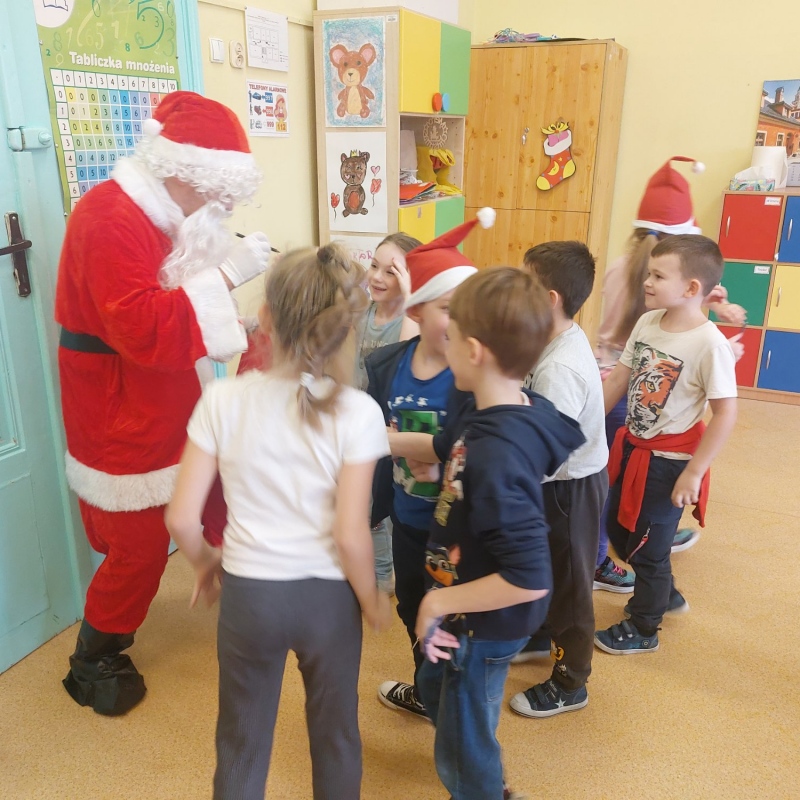 Dzieci z Mikołajem, który rozdaje podarki